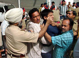 Police controls those protesting against the demolition of constructions in the Bhupindra Flour Mill area in Bathinda 