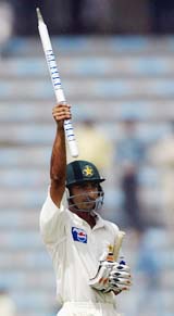 Yasir Hameed raises a stump to celebrate his team's win in the second Test match against India