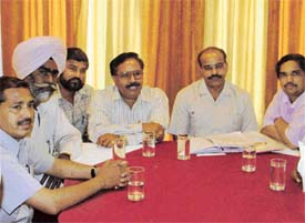 Members of the Dr Ambedkar Mission Employees Federation address a press conference
