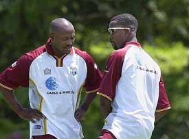 West Indies captain Brian Lara discusses on a batting position with team-mate Corey Collymore during a training session at the Stanford Cricket Ground in St John's, Antigua