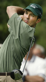 Defending champion Mike Weir from Canada watches his tee shot on the 7th hole during first round play at the Masters in Augusta