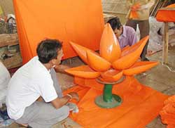 Artists give finishing touches to a wooden lotus in an Ahmedabad workshop