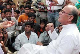 Former Prime Minister V.P. Singh listens to the grievances of slum dwellers 