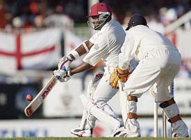 West Indies captain Brian Lara plays a shot as England wicketkeeper Geraint Jones watches 