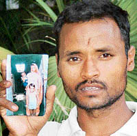Gulab Singh, a slum dweller at Indira Colony, Panchkula, shows the picture of his "mentally-disturbed" wife Sarvati and a year-old son, who suddenly disappeared from their tenement some days ago. Although a police report was lodged, Gulab Singh has not yet heard from any quarter. 