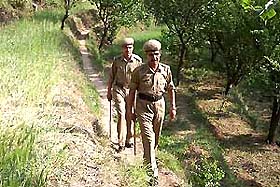 Policemen patrol the Narag area in Sirmaur district of Himachal Pradesh after the murder of two elderly Dalit men.