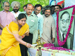 Ms Anita Arya lighting a lamp in front of a portrait of Dr B. R. Ambedkar as Mr Jagmohan and the Delhi Pradesh BJP president, Dr Harsh Vardhan, look on at the BJP office in the Capital on Monday.