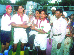 The Union Academy hockey team with the D P Joshi Hockey Trophy, presented to them by Olympian Ashok Kumar.
