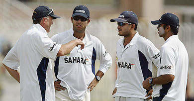 Coach John Wright has a word with Yuvraj Singh, Sourav Ganguly and Rahul Dravid during a training session