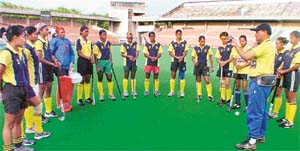Maharaj Kaushik, chief coach, gives tips to the women trainees at the Sector 42 Astro Turf stadium