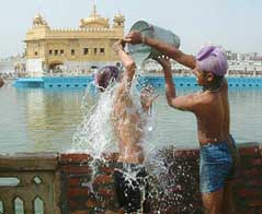 Two boys take bath in filtered water near the Golden Temple in Amritsar 