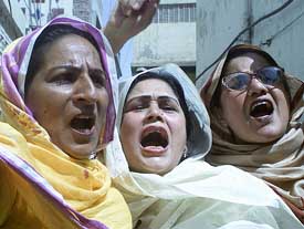 Activists of Pakistan Muslim League chant slogans opposing a jail sentence for their leader by a court in Multan 