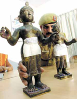 A policeman showing the seized idols at a Press conference in the Capital on Wednesday.