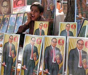 A street vendor waits for customers while selling pictures of Dr Bhim Rao Ambedkar