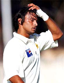 Shoaib Akhtar walks off the ground after injuring his left wrist 