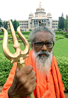 Hottepakhsa Rangaswamy (71) holds a trident during an election campaign rally outside the State Assembly building in Bangalore