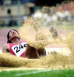 Anju Bobby George lands in the pit during the long jump event on the national circuit meet