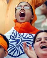 An Indian supporter wrapped in the Tricolour celebrates the victory