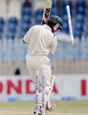 Pakistan�s Kamran Akmal is clean bowled by Laxmipathy Balaji