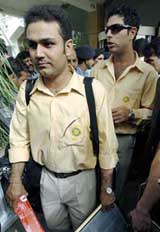 Indian cricketers Virender Sehwag and Yuvraj Singh prepare to board a bus