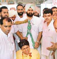 The Congress candidate, Mr Munish Tiwari, being weighed against coins in Ludhiana
