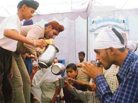 Devotees serve sweetened water at a Sarabha Nagar gurdwara in Ludhiana