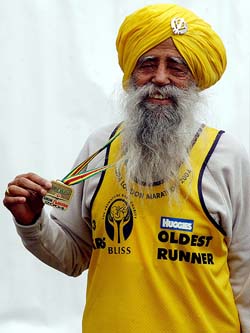 The oldest runner in the London Marathon, 93-year-old Fauja Singh, poses for photographers 