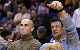 US actor Sylvester Stallone and tennis star Andre Agassi watch the NBA Western Conference playoff match between Los Angeles Lakers and Houston Rockets 
