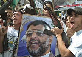 Palestinian militants from Hamas raise slogans against the USA and Israel during a demonstration at the Ain al-Hilweh refugee camp in south Lebanon on Sunday.
