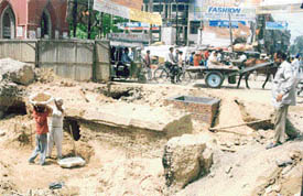 A portion of road dug for shifting of water mains near Clock Tower Chowk