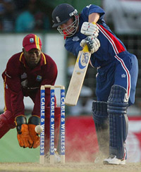 West Indian wicketkeeper Ridley Jacobs looks on as England's Chris Read hits a shot during the first ODI in Georgetown
