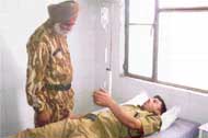 A senior ITBP official enquires about the health of an injured jawan at a hospital