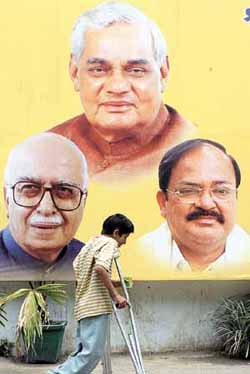 Unmindful of the portraits of BJP bigwigs outside the Ashoka Road office of the party