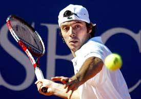 Sebastien Grosjean of France hits a forehand return to compatriot Arnaud Clement 