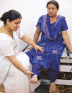 Dr Harcharan Kaur taking a look at a patient