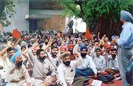 Members of the Daily Paid Labour Union, Punjab Agricultural University, at a rally organised outside Thapar Hall on the campus, on Wednesday. 