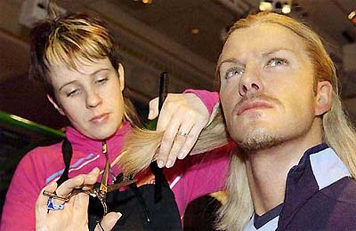The waxwork model of David Beckham has his hair cut at Madame Tussauds Wax Museum in London 