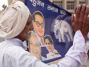 A BSP worker carries a flag printed with portraits of party leaders Kanshi Ram, Mayawati and Dr Bhim Rao Ambedkar in Patiala