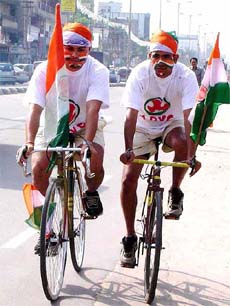 Two Assam Pradesh Youth Congress members during a bicycle rally as a part of the Lok Sabha election campaign in Upper Assam in Guwahati