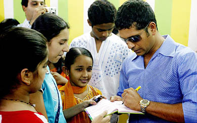 Sachin Tendulkar signs autographs after inaugurating a school in Mumbai