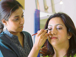 Neha Singh, L'Oreal�s make-over artiste, designs a client�s look at L'Oreal studio in Chandigarh on Saturday.