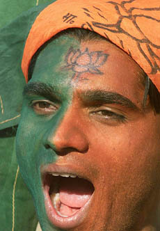 An activist of the BJP with his face painted in party flag colours chants pro-party slogans during an election rally in Chandigarh on Saturday.