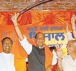 Union Agriculture Minister Rajnath Singh brandishes a sword at an election rally of BJP candidate Satya Pal Jain at Behlana in Chandigarh