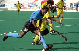 Indian forward Sandeep Michael breaks Malaysian defence during their match at the 5th Junior Men�s Asia Field Hockey Tournament in Karachi