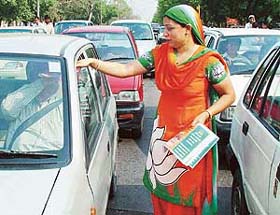 An activist of the BJP Mahila Morcha campaigns for Mr Satya Pal Jain, a BJP candidate for the forthcoming Lok Sabha election, at Press Chowk in Chandigarh