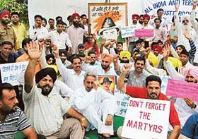 Members of the All-India Anti-Terrorist Front protest in front of the Punjab School Education Board office