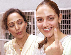 First-time voter Esha Deol show her marked finger as her mother and Rajya Sabha member Hema Malini looks on at a polling station in Mumbai on Monday. 