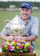 Hale Irwin poses with his trophy on the 18th green after winning the PGA Champions Tour�s Liberty Mutual Legends of Golf