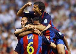 Barcelona�s Xavi Hernandez is congratulated by team-mates Luis Enrique (L) Giovanni Van Bronckhorst (top) and Patrick Kluivert after scoring the second goal against Real Madrid