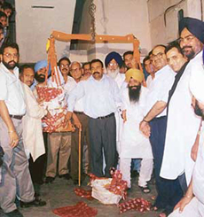 SAD-BJP candidate Sharanjit Singh Dhillon being weighed against sweetmeats by Geetanjali Apartments Welfare Society members in Ludhiana on Tuesday. 